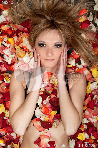 Image of blonde lying in rose petals