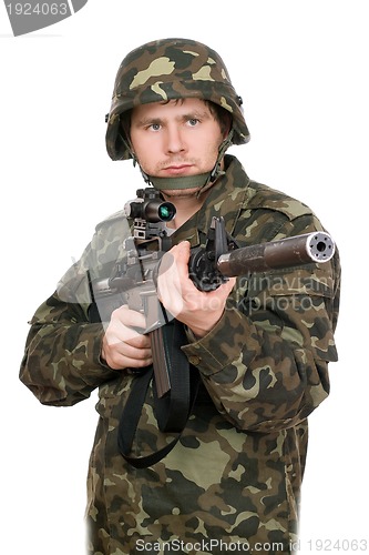 Image of Armed soldier pointing m16. Upperhalf