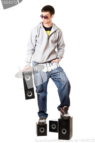 Image of man in sunglasses standing on the speakers