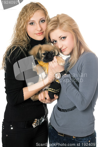 Image of two beautiful young women with pekingese