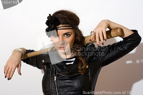 Image of Serious young woman with a bat