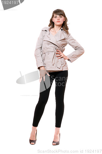 Image of Pretty young woman wearing a coat and black leggings