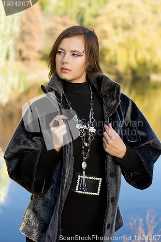 Image of young woman in autumn park