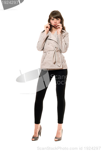 Image of Sexy girl wearing a coat and black leggings. Isolated