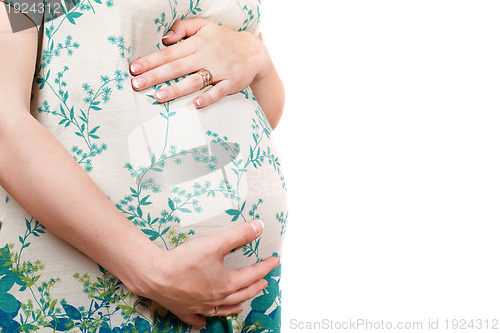 Image of Belly of a pregnant girl in dress. Isolated