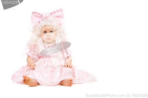 Image of Sad baby girl in a pink dress