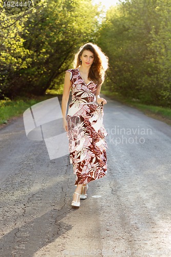 Image of young woman walking on the road