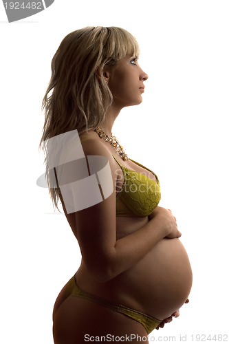 Image of Pregnant young woman in yellow lingerie