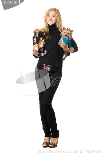 Image of Smiling pretty young blonde posing with two dogs