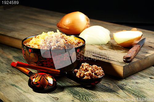 Image of Spoon and bowl of buckwheat.
