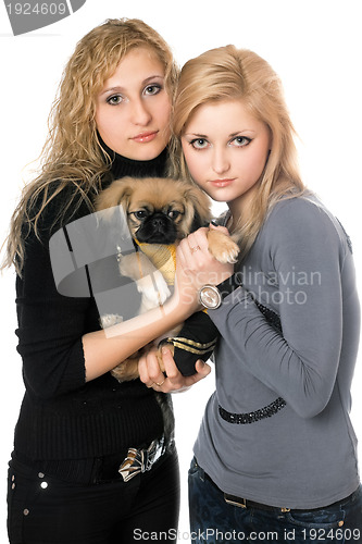 Image of two pretty young women with pekingese