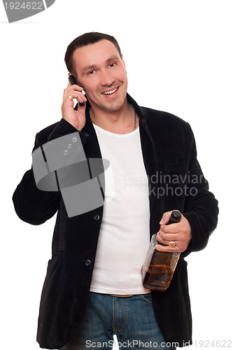 Image of Smiling man with a phone and bottle of scotch