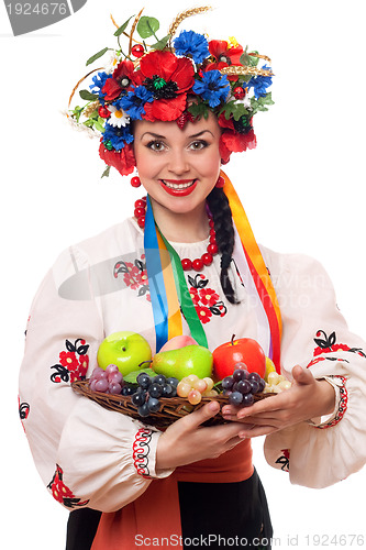 Image of woman in the Ukrainian national clothes with fruit
