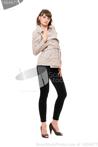 Image of Sexy young woman wearing a coat and black leggings