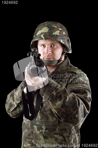 Image of Armed man pointing a rifle