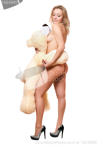 Image of young woman posing with large teddy bear