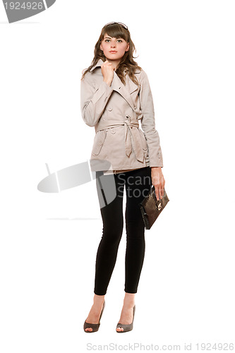 Image of Charming girl wearing a coat and black leggings