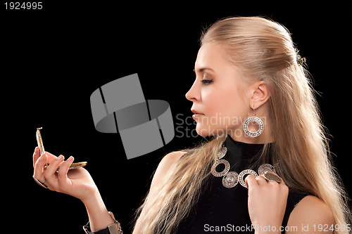 Image of young blonde with a mirror