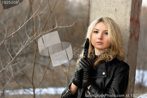 Image of Sensual young woman holding a weapon