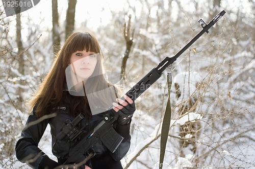 Image of Armed young lady with a gun