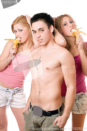 Image of Young man and two beautiful women with bananas