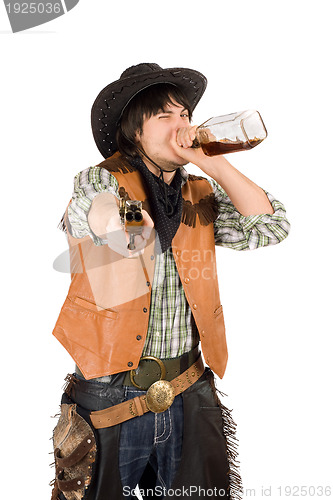Image of Cowboy drinking whiskey from the bottle