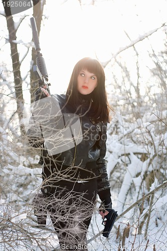 Image of  sexy young lady with a rifle