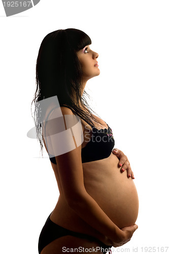 Image of Pregnant young brunette in black lingerie