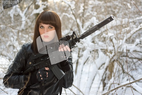 Image of Portrait of young lady with a rifle