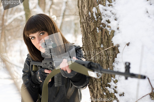 Image of young lady with a sniper rifle 