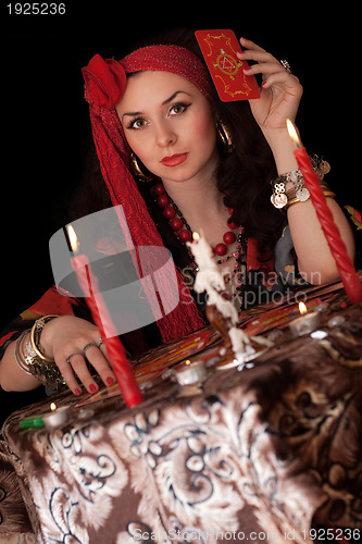 Image of Gypsy woman sitting with cards. Isolated