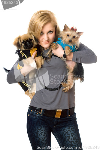 Image of Smiling young blonde posing with two dogs