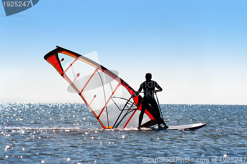 Image of Windsurfer picks up the sail