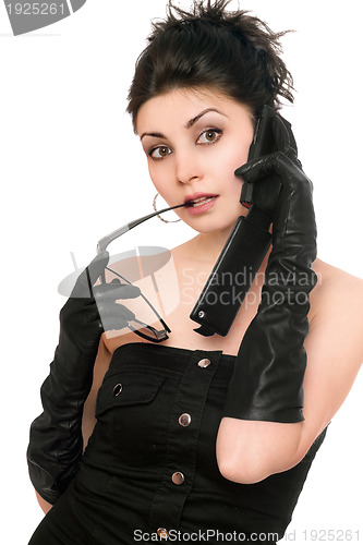 Image of Portrait of surprised young woman talking on the phone