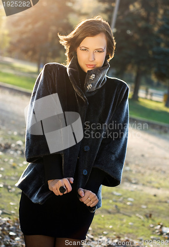 Image of hot young woman in autumn park