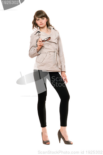 Image of Attractive girl wearing a coat and black leggings. Isolated 