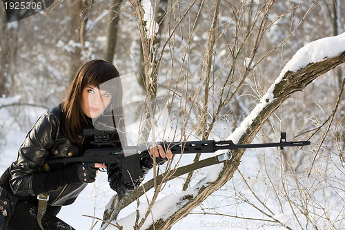 Image of young woman with a sniper rifle