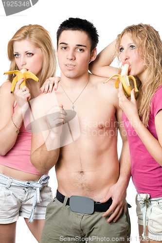 Image of Young man and two attractive women with bananas