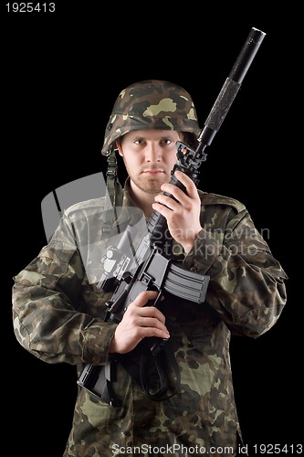 Image of Alerted soldier raised m16 in studio