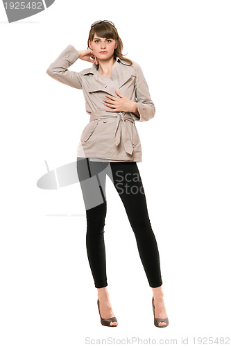 Image of Cute young woman wearing a coat and black leggings