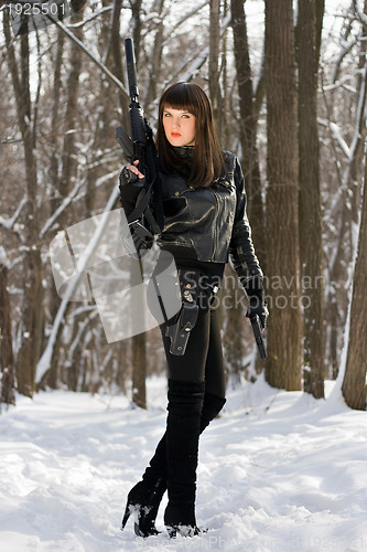 Image of Strong young woman with a rifle