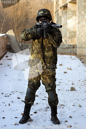 Image of Soldier in camouflage with rifle