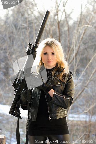 Image of young blonde with a gun