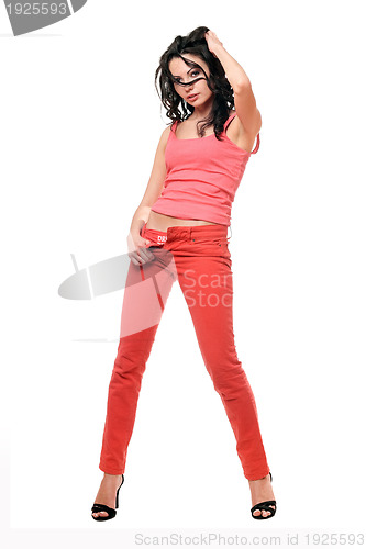 Image of Beautiful young brunette in a red jeans