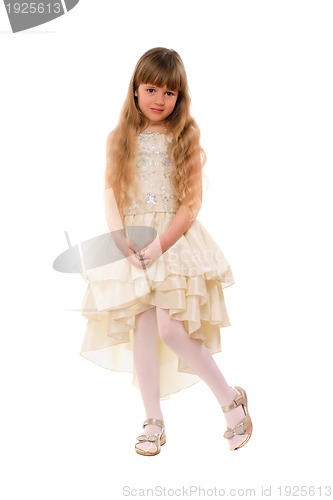 Image of Cute little girl in a beige dress