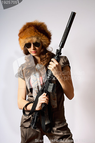 Image of Beautiful armed girl in hat