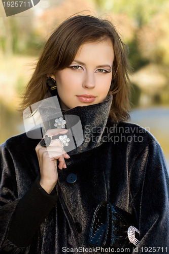 Image of attractive young woman in autumn park