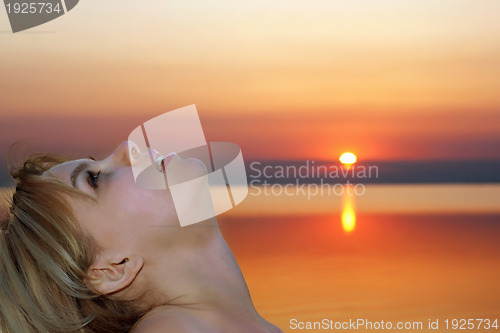 Image of pretty young blonde at sunset