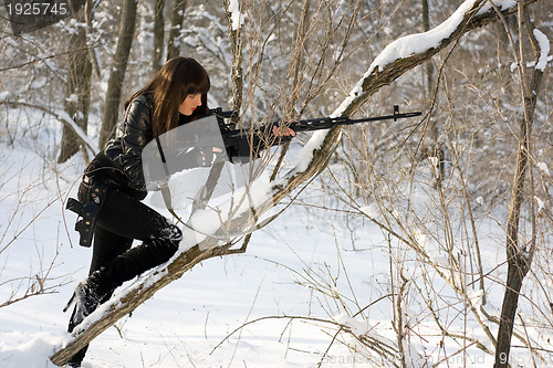 Image of Young woman with a sniper rifle