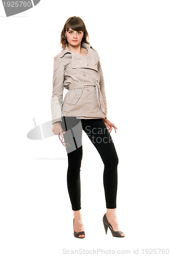 Image of Charming girl wearing a coat and black leggings. Isolated